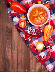 Chili con carne in a clay bowl on a concrete or stone rustic background- traditional dish of mexican cuisine.Top view.