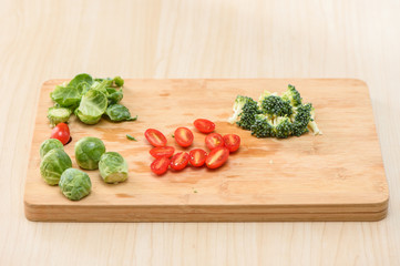 the process of chef cooking -cabbages, tomatoes, cauliflowers on cutting board
