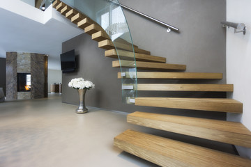 elegant wood and glass staircase in luxury home - 186522252