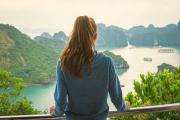 Woman look on HALONG bay in Vietnam from TiTop island. UNESCO World Heritage Site.