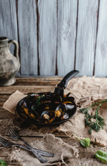 gourmet fried mussels with shells on frying pan and forks on table