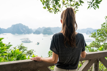 Woman look on HALONG bay in Vietnam from TiTop island. UNESCO World Heritage Site.