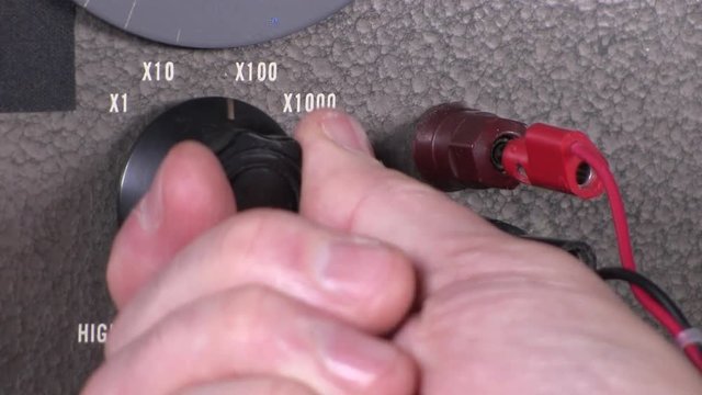 Close-up macro of decreasing and increasing output high cut-off frequency dial adjustment to variable band-pass filter vintage electronic hardware engineering military equipment