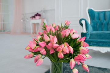 Pink tulips bouquet in a glass vase 
