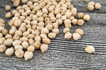 dry chickpea pictures in the bowl over the wooden floor,
ready to cook dried chickpeas dish


