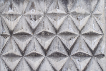 Fototapeta premium Background texture of gray concrete fence with triangular pattern