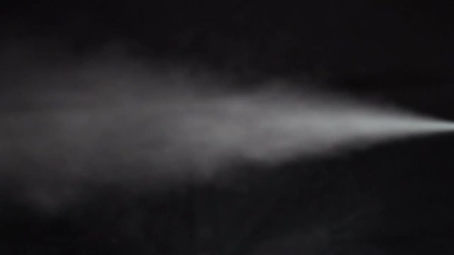 Stream of white smoke on an isolated black studio background