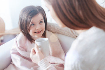 It is better already. Beautiful child keeping smile on her face and sitting opposite her mother...