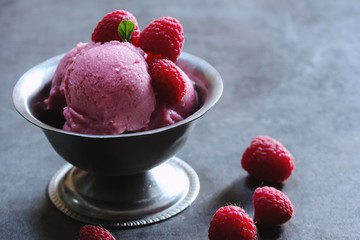 Homemade Raspberry ice cream topped with fresh berries, selective focus