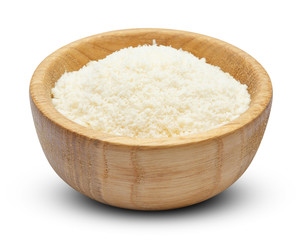 grated Parmesan cheese in wooden bowl on white background