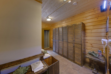 The room with wooden cases, brooms and caps for a bath