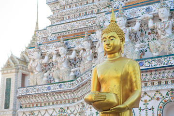 Bangkok , Thailand - 22 December, 2017: Golden buddha statue at white pagoda in Wat Arun Ratchawararam Ratchawaramahawihan