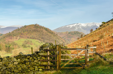 A wooden gate on a hillside in the English lake District with Blencathra in the background