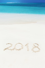 Handwritting inscription 2017 on sandy beach