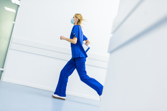 Hurry Female Surgeon In Medical Masks With Diagnosis Running In Hospital Corridor