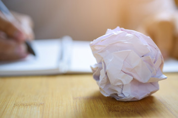 crumpled paper ball on table