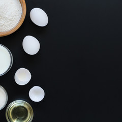 Ingredients for cooking on black background. Recipe of Russian pancakes