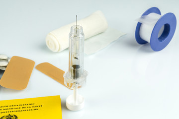 Medical tape with syringe and plaster and vaccination card, white background