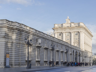 Fototapeta na wymiar Tourists at The entrance of the Royal palace. Madrid, Spain.