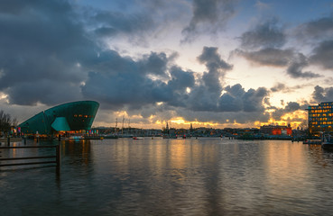 Panorama of the Oosterdok canal in the center of Amsterdam with NEMO Science Museum on the left