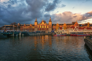 Fototapeta na wymiar The Central Station of Amsterdam in the light of the setting sun