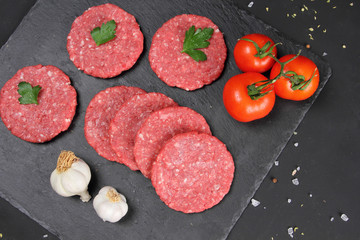 Raw Uncooked Meat Balls on the Black Background