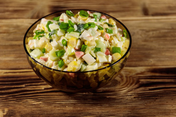Salad with crab sticks, sweet corn, cucumber, eggs, rice and mayonnaise