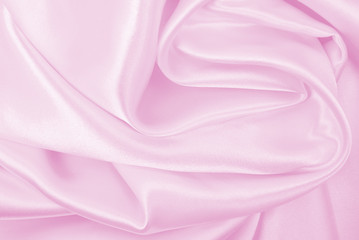 Smooth elegant pink silk or satin texture as wedding background. Luxurious background design