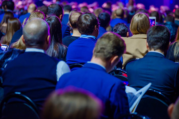 People attend business conference in the congress hall