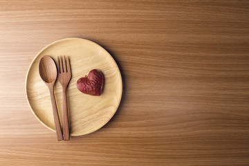 dinner with love heart in valentine concept on wood ground