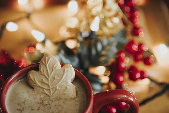 Close-up of cookie in hot chocolate by decoration on table during Christmas