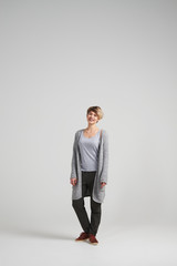 Attractive woman wearing cardigan posing at studio