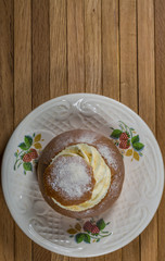 Top View of Semla Cake on saucer on wooden table
