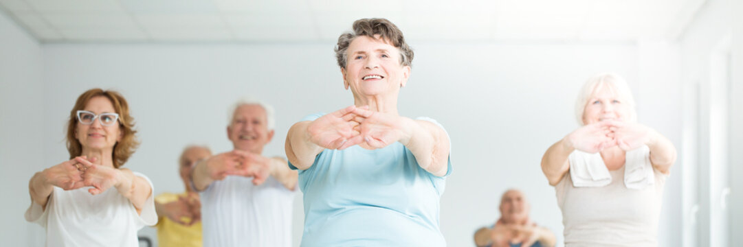 Smiling elderly woman stretching