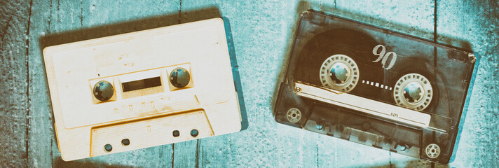Old cassette tapes with a wooden background