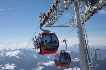 some skiing people in a funicular cahir lift are going to the top of the mountain to do some winter...
