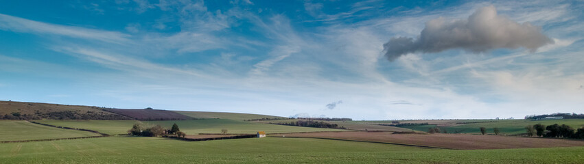 Panorama of Old WInchester Hill Iron Age Fort on South Downs near Warnford and Exton on a bright winter day with isolated flint build shepherds hut