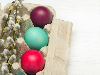 Easter background with eggs and catkins on wooden background, copy space