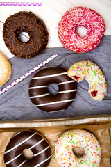Colorful donuts with chocolate and icing, selective focus