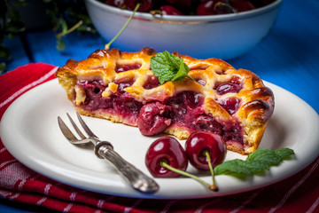 Homemade cherry pie on blue table.