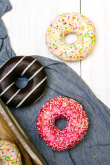 Colorful donuts with chocolate and icing, selective focus