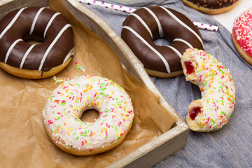 Colorful donuts with chocolate and icing, selective focus