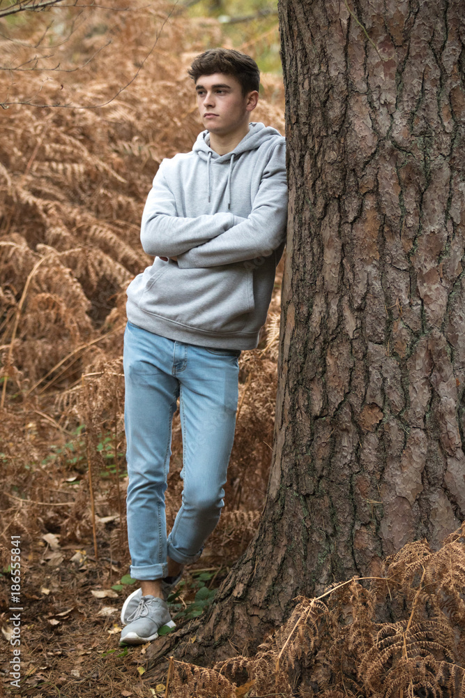 Wall mural Teenage boy in the woods on an autumn day