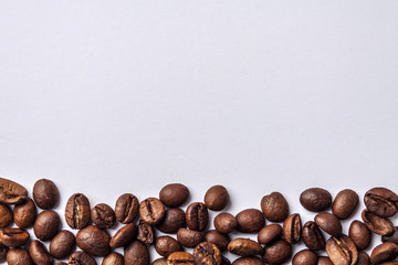 Background from organic horizontal spilled coffee arabica in beans with white space for text