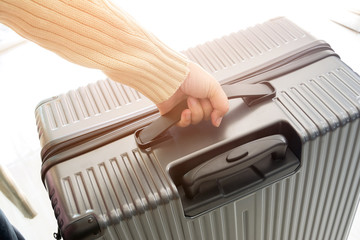 woman holding luggage bag