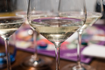 Glasses of sparkling wine with small bubbles rising. Transparent crystal wine glasses with bubbles