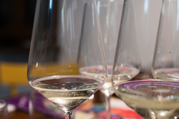 Glasses of sparkling wine with small bubbles rising. Transparent crystal wine glasses with bubbles