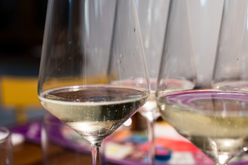 Glasses of sparkling wine with small bubbles rising. Transparent crystal wine glasses with bubbles