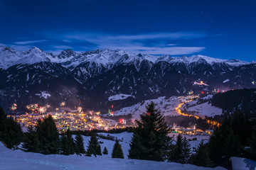 New Years Eve fireworks over village Fiss in Austria with snowy mountains