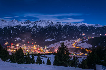 New Years Eve fireworks over village Fiss in Austria with snowy mountains